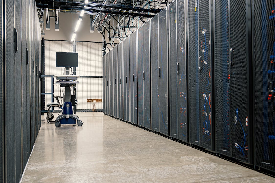 A modern data center corridor lined with server racks powering cloud database infrastructure
