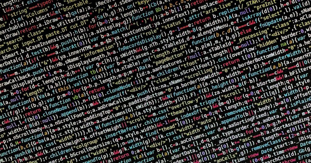 Colorful lines of code on a dark monitor screen in a development environment