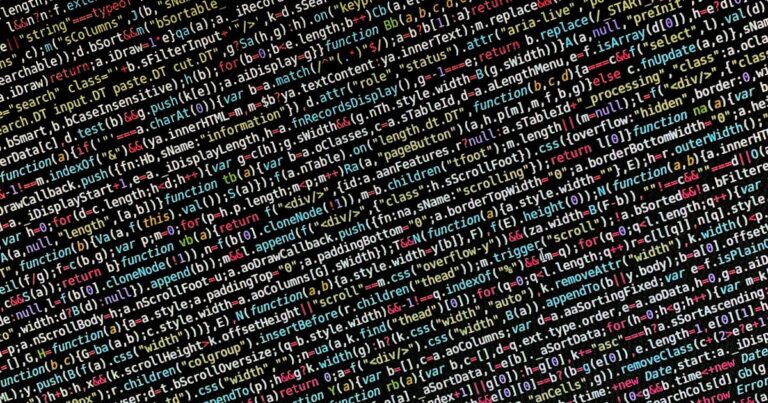 Colorful lines of code on a dark monitor screen in a development environment