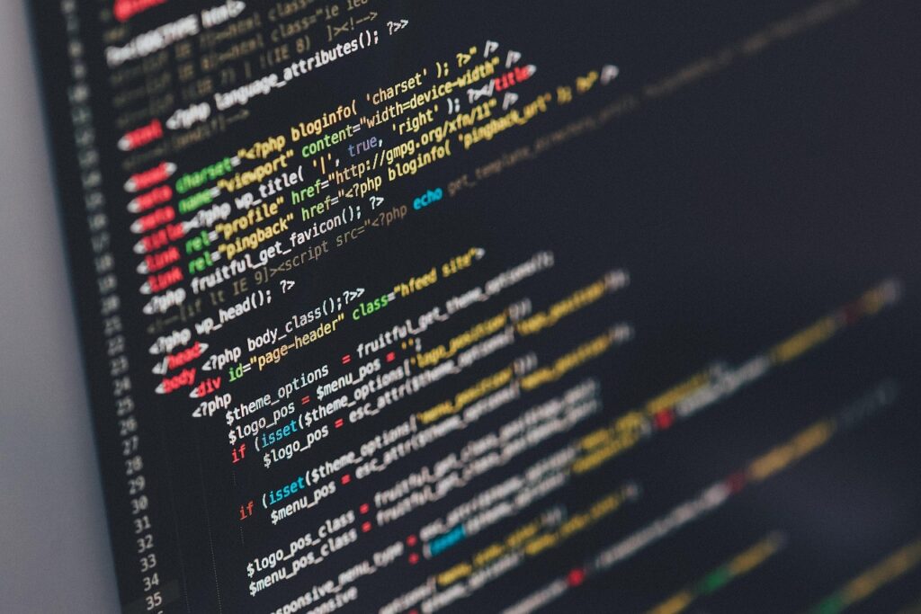 PHP code displayed on a dark monitor screen showing programming syntax