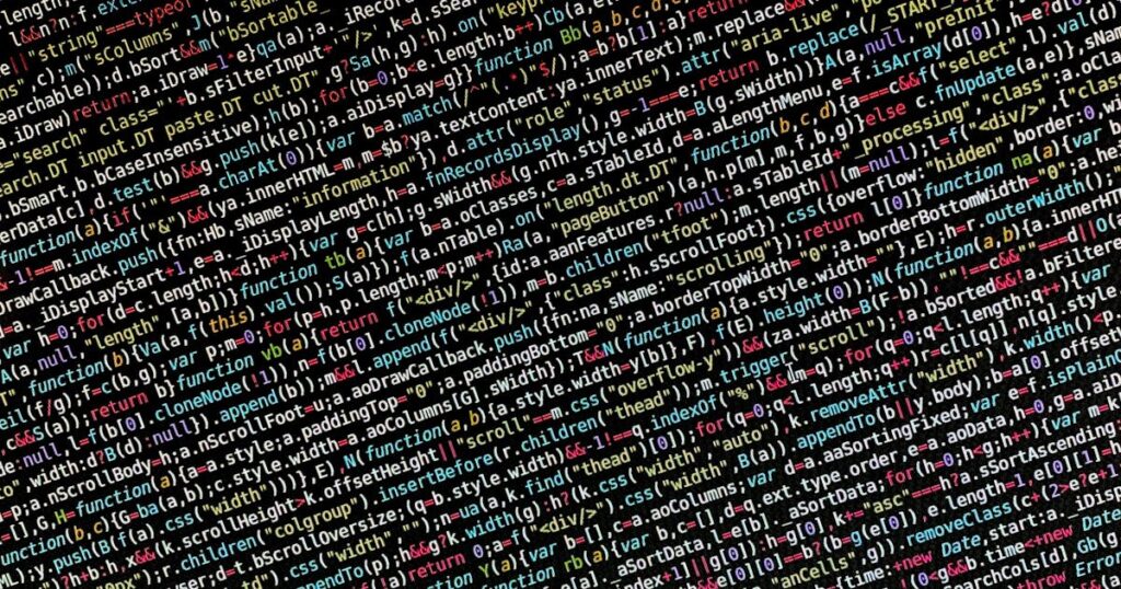 Colorful lines of code on a dark monitor screen in a development environment