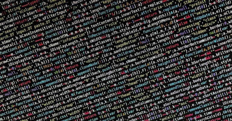 Colorful lines of code on a dark monitor screen in a development environment
